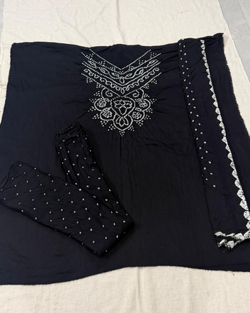 Black Bandhani fabric with on a beige surface