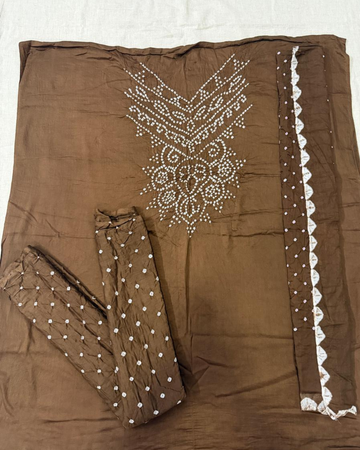 Brown bandhani fabric on a white background