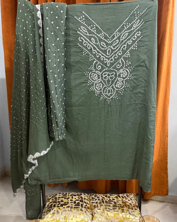 Gray Bandhani fabric draped over a chair with a wooden background