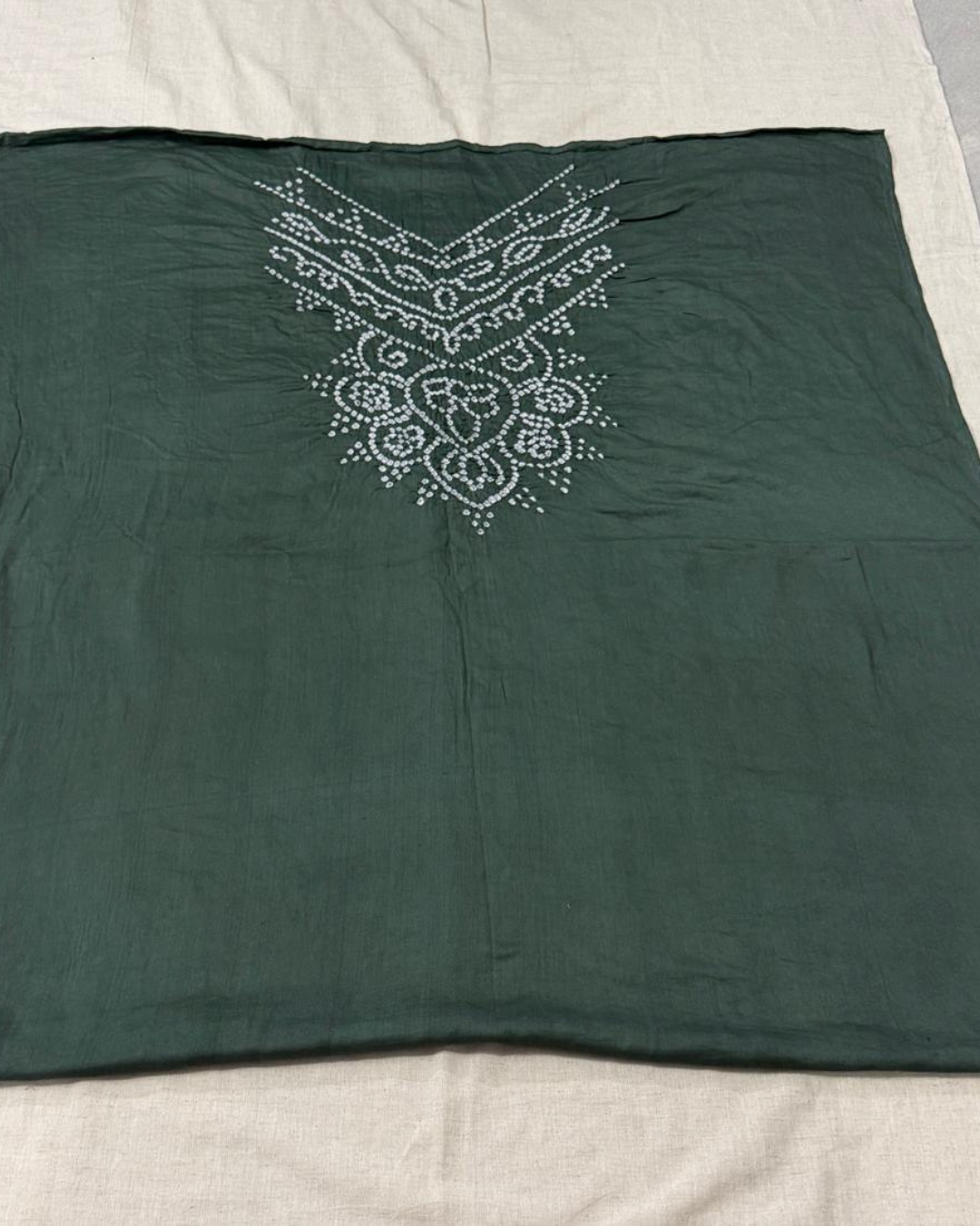 Gray Bandhani fabric with on a beige surface