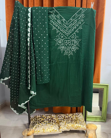 Green Bandhani fabric draped over a chair with a mirror in the background