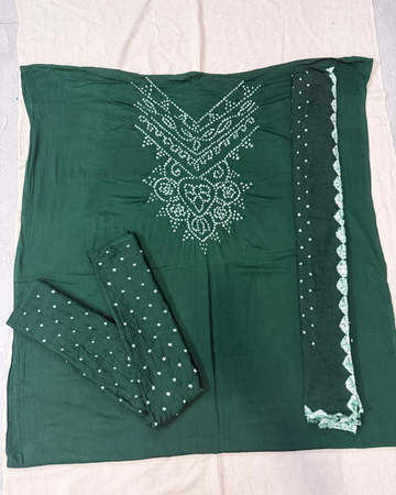 Green bandhani suit fabric on a white background