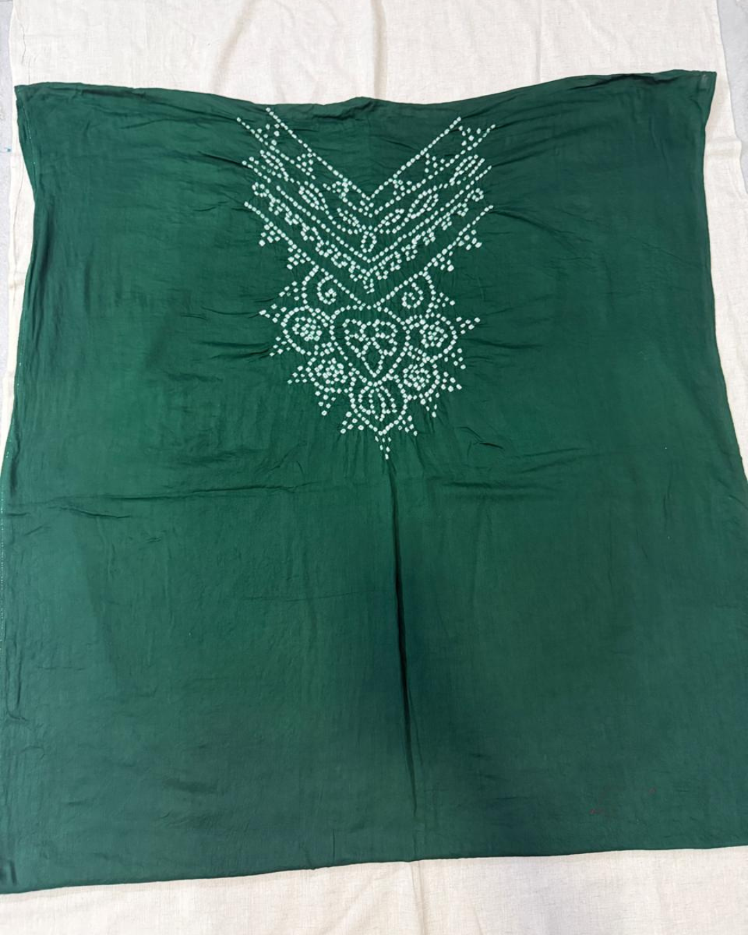 Green bandhani top on a white background
