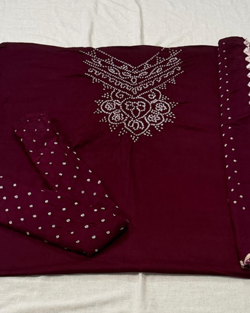 Maroon bandhani fabric on a white background