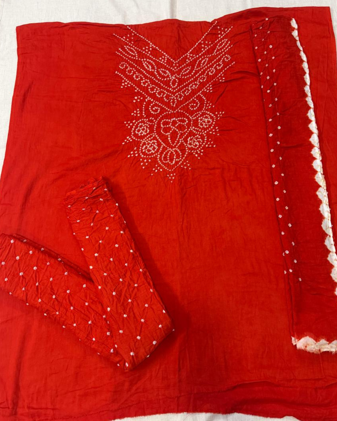 Orange Bandhani fabric on a white background