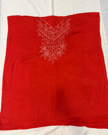 Orange Bandhani fabric on a white background