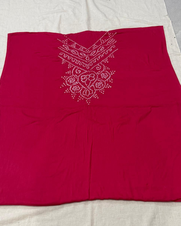 Pink bandhani fabric on a light gray background