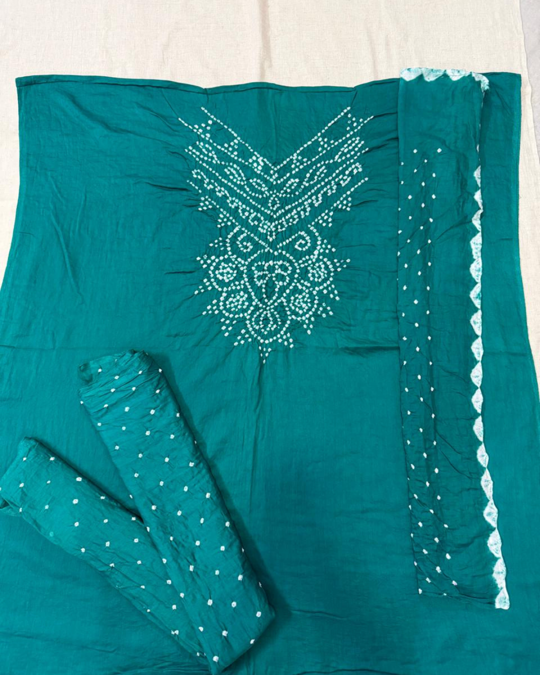 Rama Green bandhani fabric on a beige background