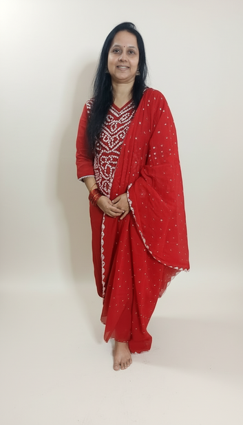 Woman wearing a red traditional outfit with a white background