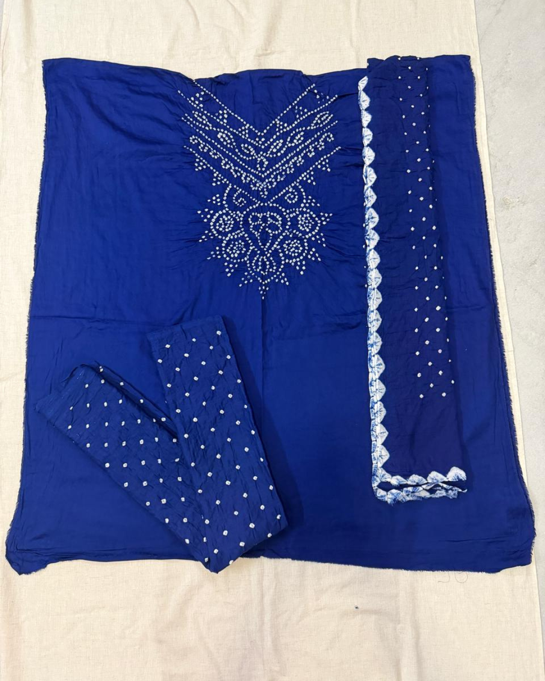 Blue Bandhani fabric with on a beige background