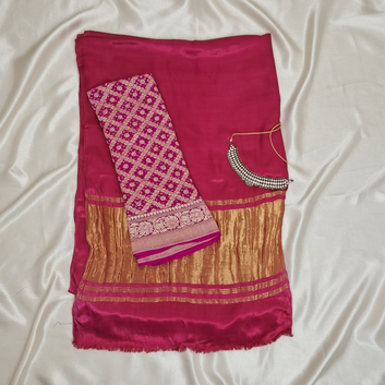 Pink and gold saree with a matching blouse on a off white satin background