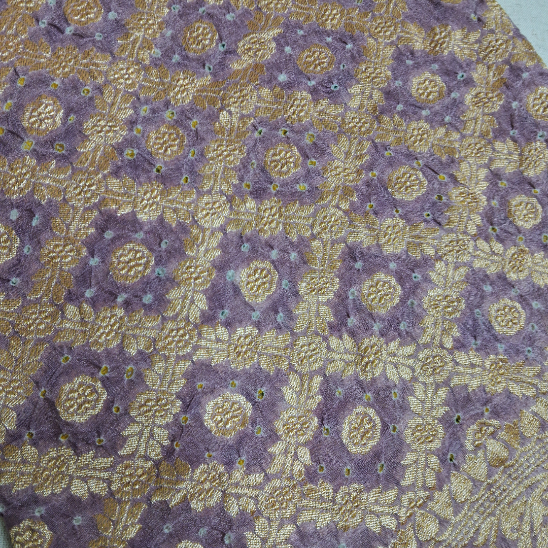 close up of white dana bandhej on banarsi  georgette wine blouse piece