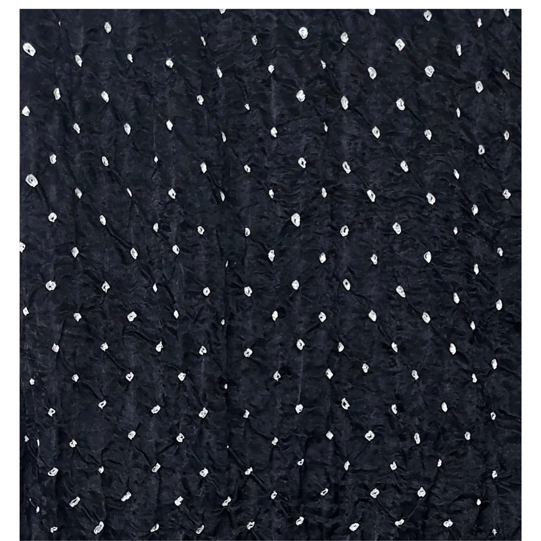 close up of white bandhej on black fabric