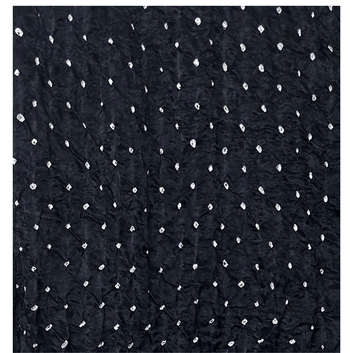 close up of white bandhej on black fabric
