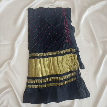 black bandhani blouse piece on off white satin background