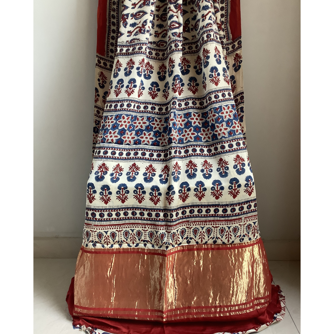 ajrakh block print saree on a plain background