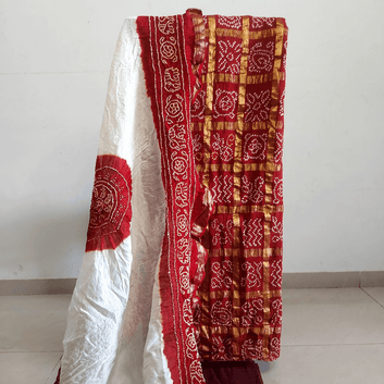 Red and white patterned fabric draped over a white surface