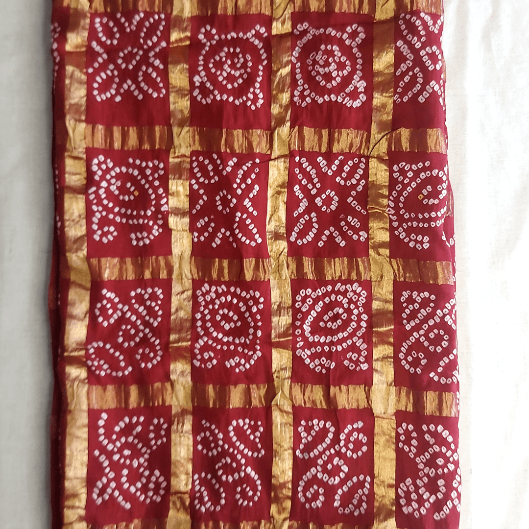red golden checks bandhani fabric on white floor