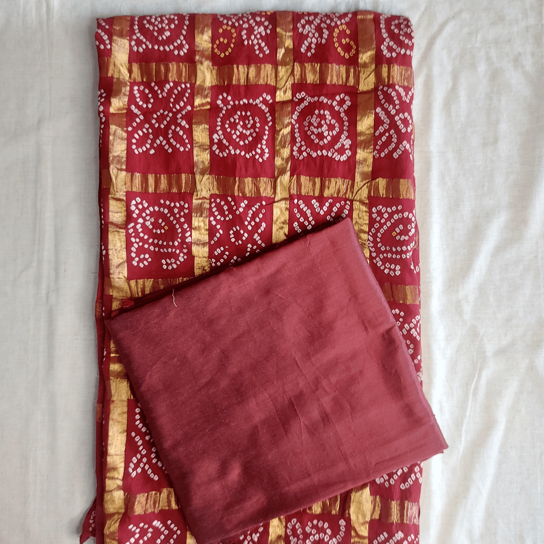 Red and gold patterned fabric on a white background