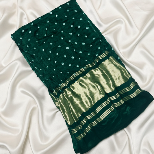 green gajji silk bandhani blouse piece on off white satin background