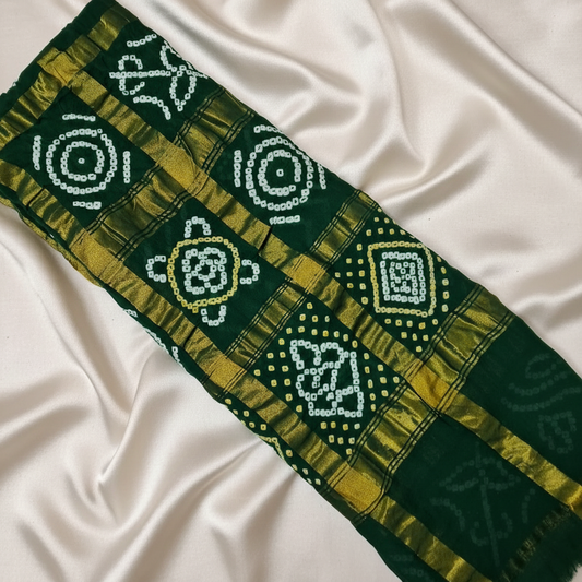 handloom cotton green gharchola bandhani blouse piece flat lay on white fabric