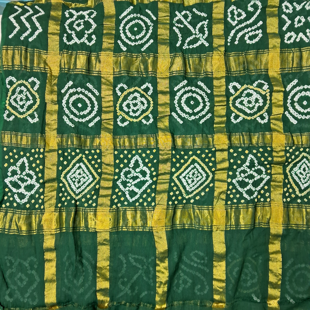 close up of green gharchola bandhani blouse piece with white and yellow bandhej