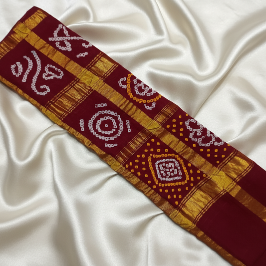 handloom cotton maroon gharchola bandhani blouse piece flat lay on white fabric