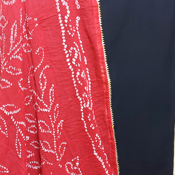 close up of handmade bandhani dupatta and plain black fabric