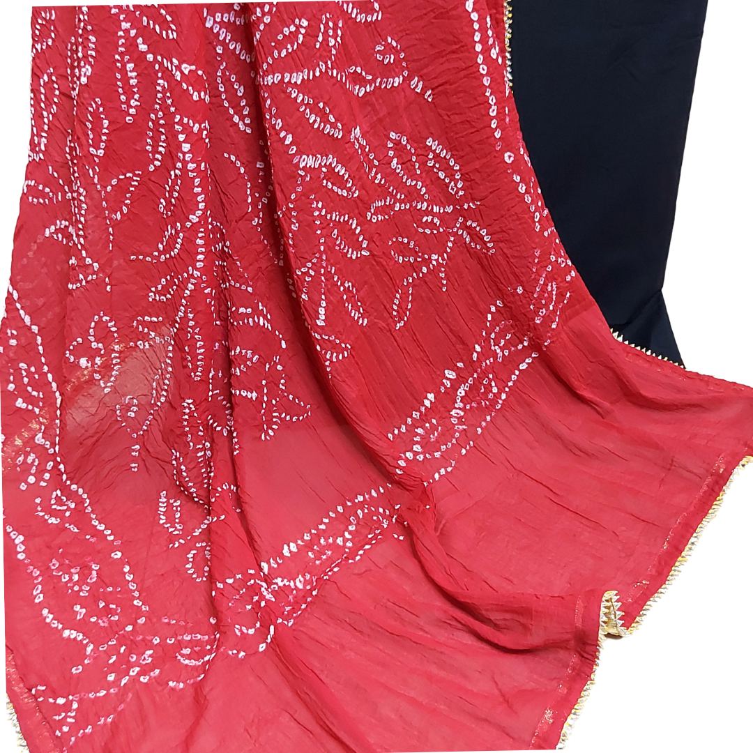 close up of red bandhani dupatta with white bandhej