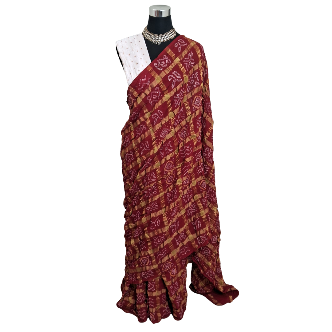 handloom cotton Red gharchola bandhani  saree on a mannequin with a white background