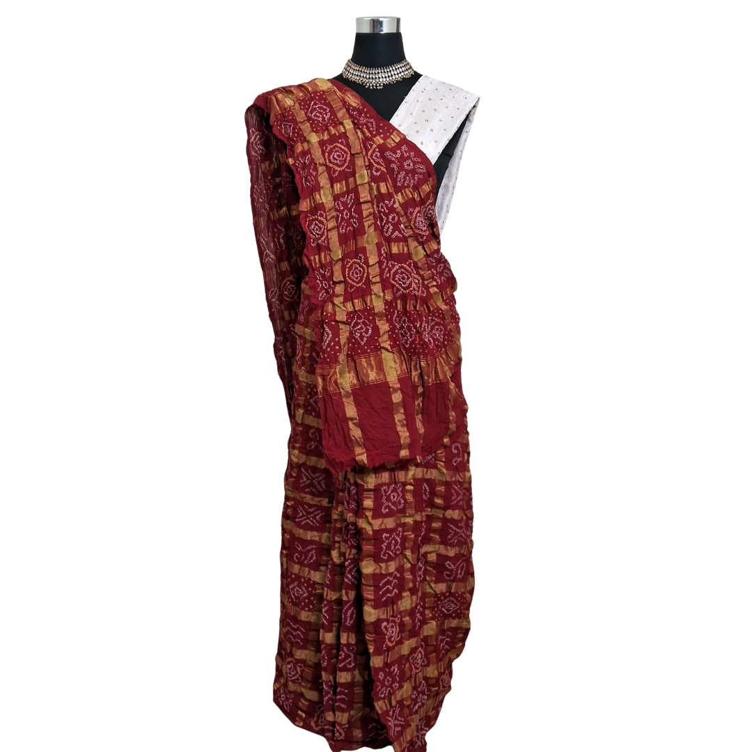 handloom cotton red gharchola bandhani  saree on a mannequin with a white background