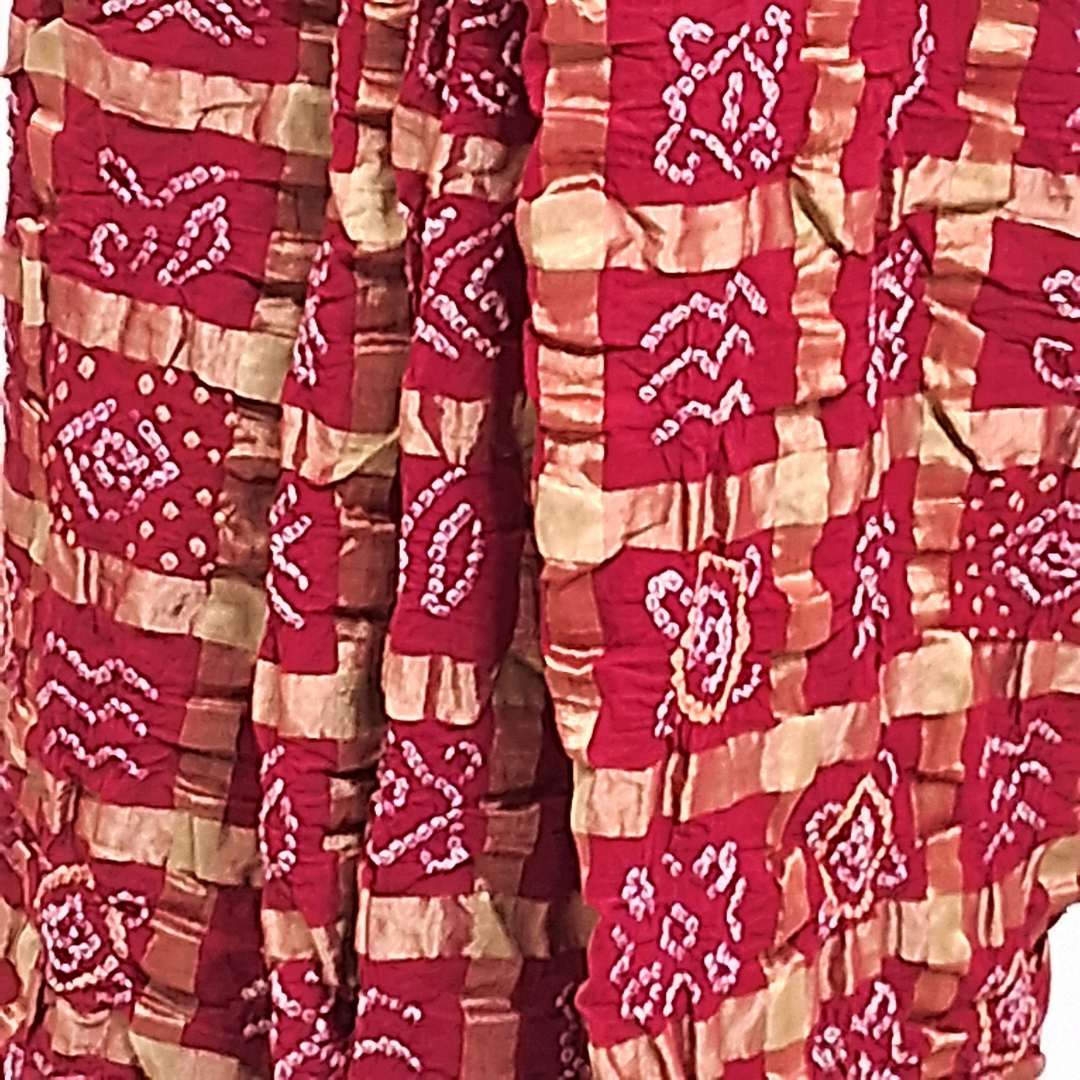 Close-up of a red gharchola bandhani saree