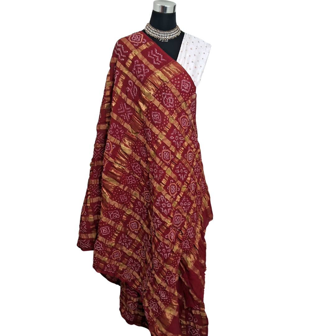 handloom cotton red gharchola bandhani full saree on mannequin with a white background