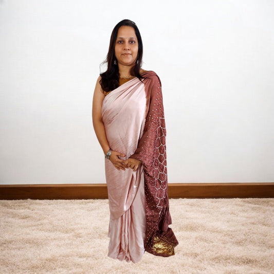Woman wearing a rose gold saree with a white background