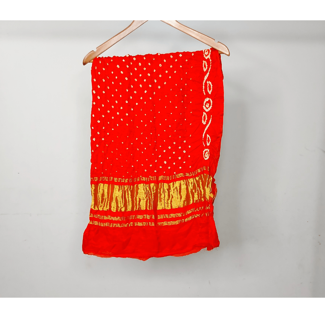 Orange bandhani blouse piece on hanger