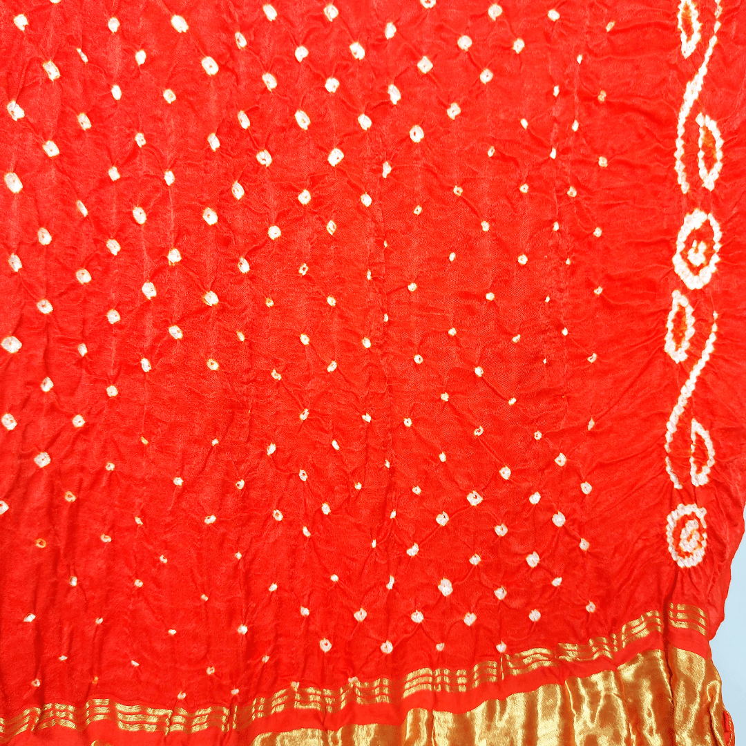 close of bandhani on orange blouse piece