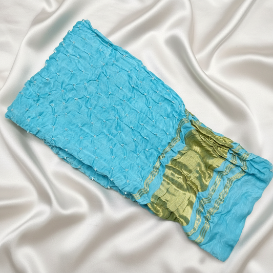 Blue and golden bandhani blouse piece  on a white satin background