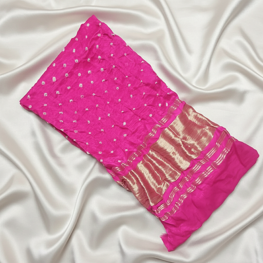 pink bandhani blouse piece on off white satin background