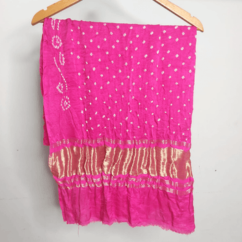 pink bandhani blouse piece on hanger