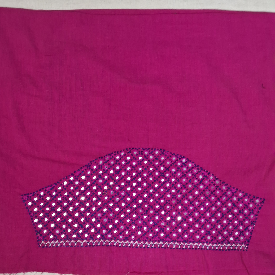A magenta pink fabric panel featuring a decorative arch-shaped embroidered and mirror-work section at the bottom with white, pink, and blue details.