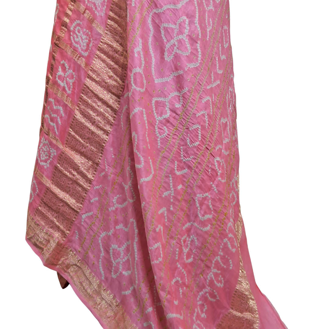 Pink gajji silk gharchola  bandhani saree with gold and white patterns on a white background
