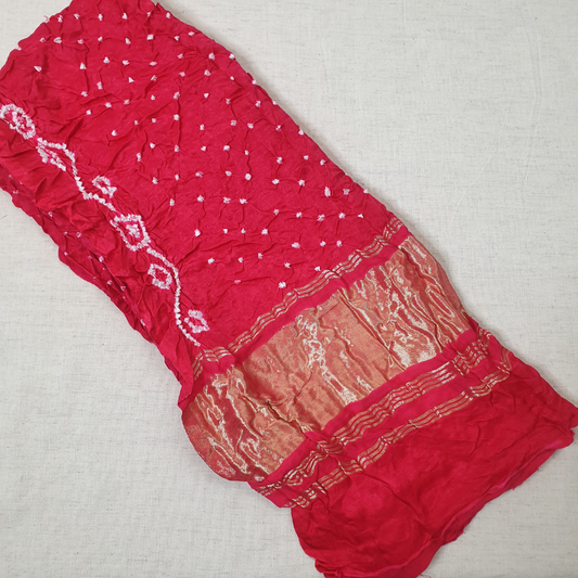pure gajji silk tomato red dana bandhani blouse piece with lagadi patta flat lay on white background