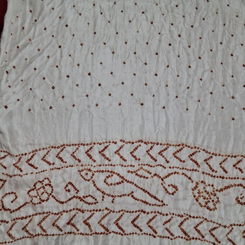 close of red bandhani on white pure gajji silk blouse piece