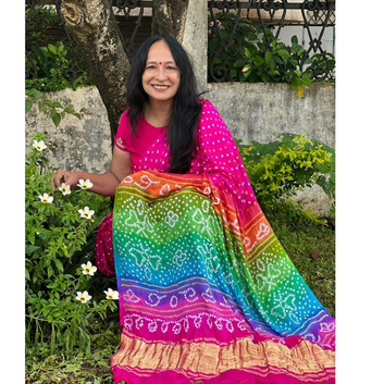 Woman wearing a colorful saree in a garden setting
