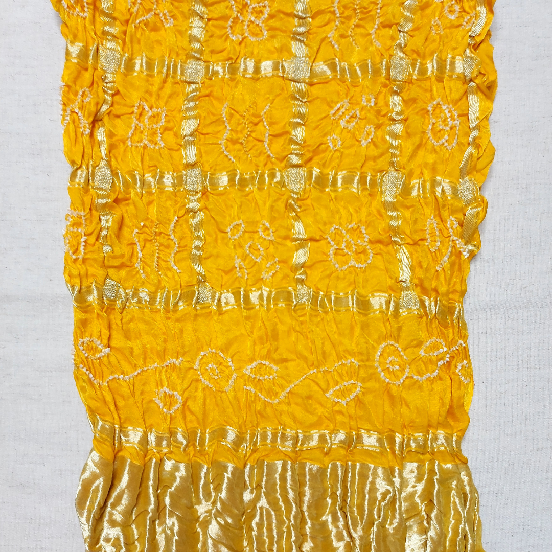 close up of pure gajji silk gharchola bandhani blouse piece with white bandhej