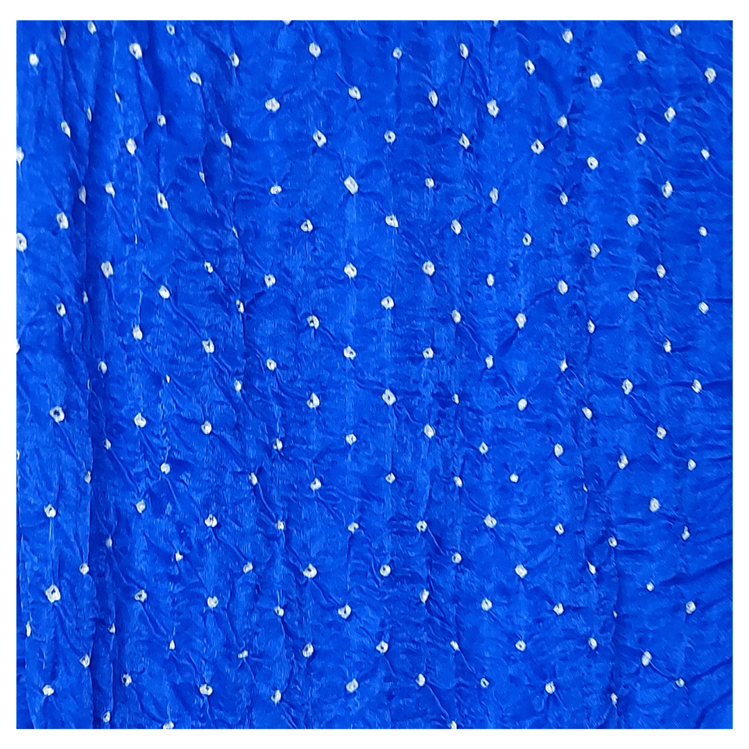 close of white bandhej on royal blue fabric
