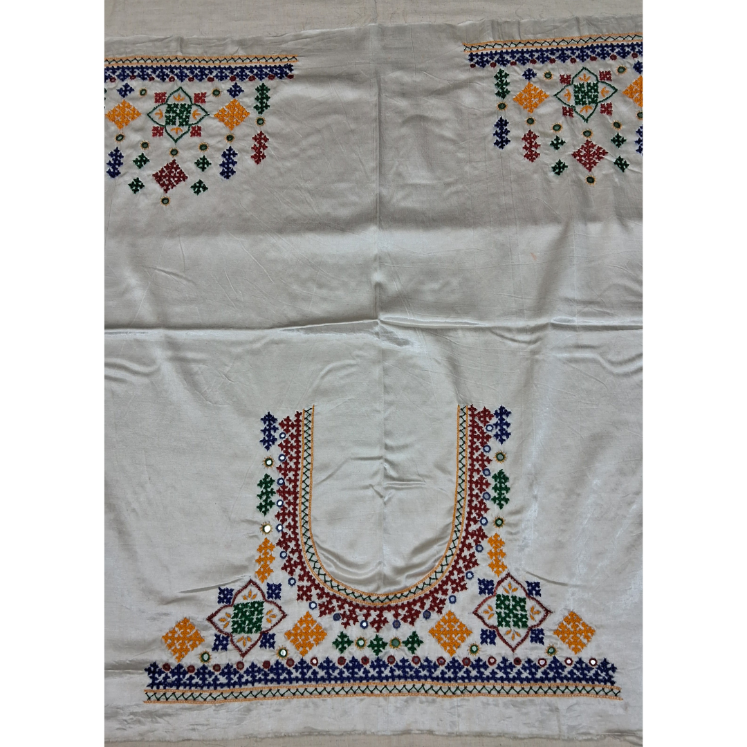 An off-white or cream-colored blouse fabric featuring detailed, colorful hand-embroidered geometric patterns, including a large U-neckline design and matching motifs on the shoulders.