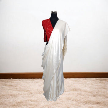 White saree with red blouse on a mannequin against a white background